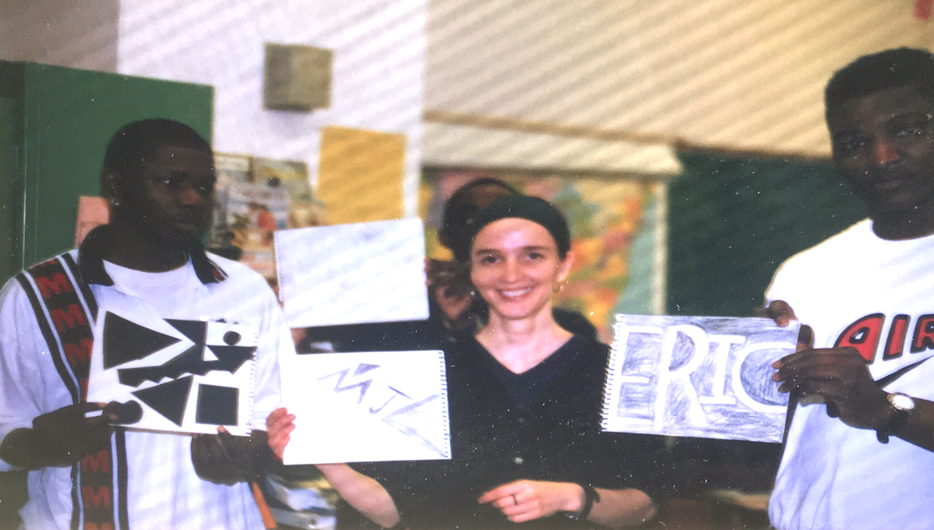 Molly with students holding art for picture books.