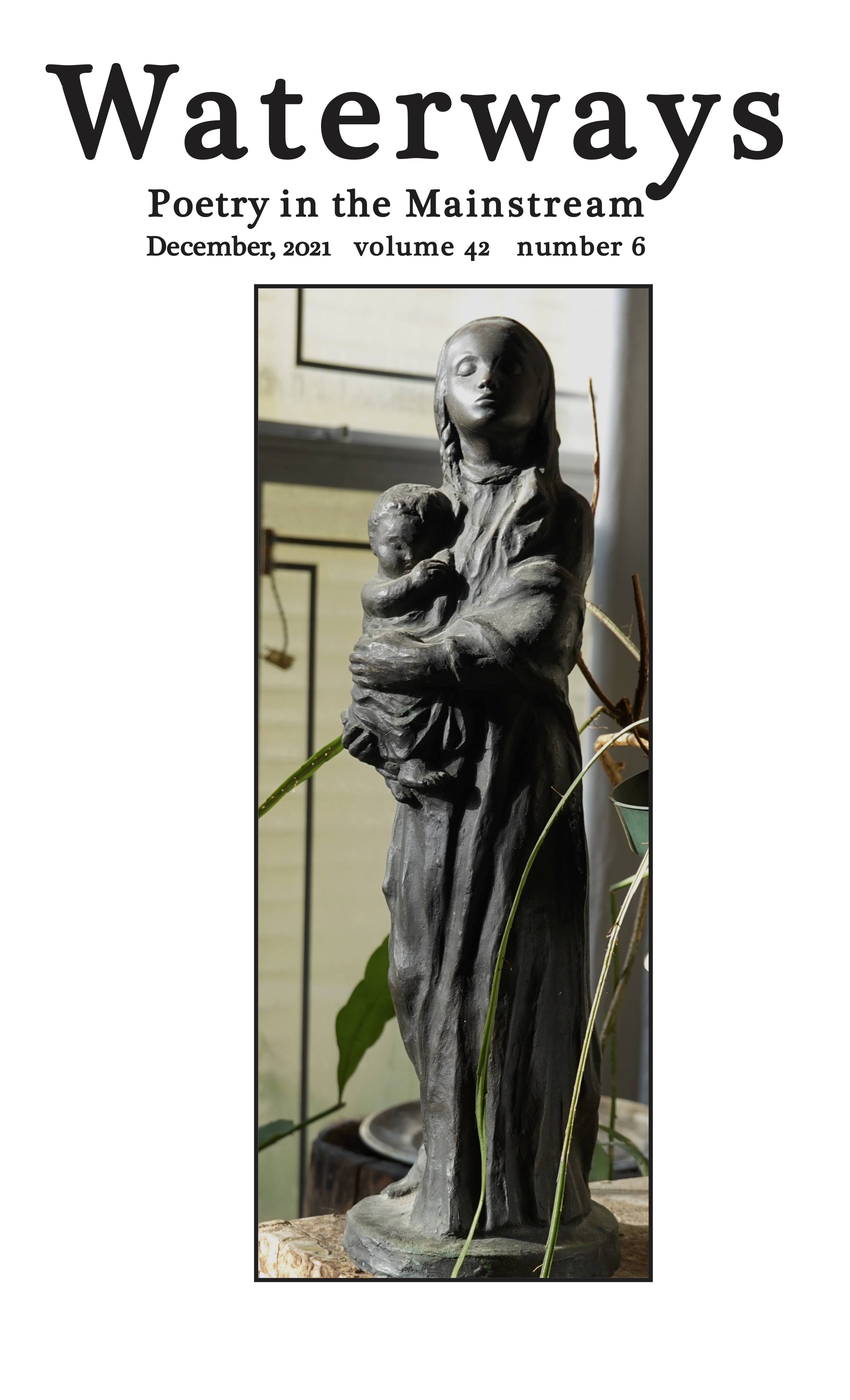 bronze sculpture of a madonna and child is paired with an adoring chinchilla.