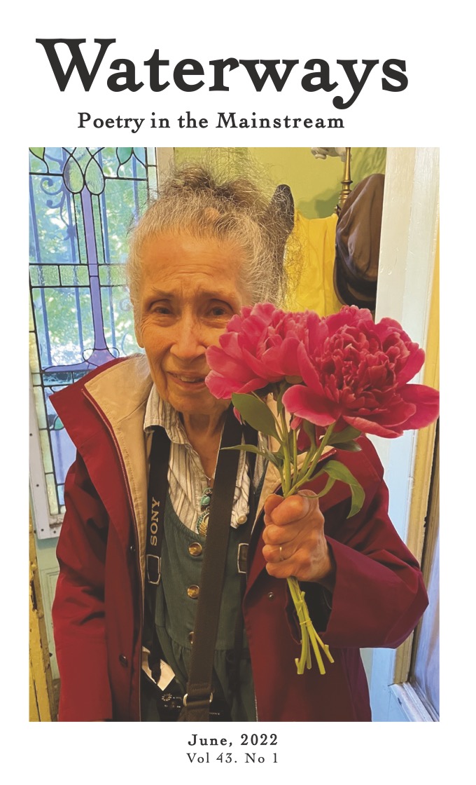 Cover for June is a photograph of Barbara Fisher holding a red flower